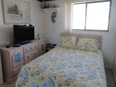 Bedroom with queen bed and TV